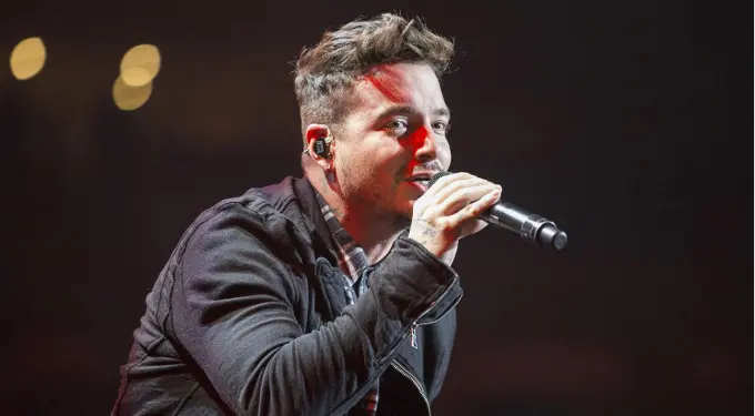 Colombian singer J Balvin singing on stage with microphone
