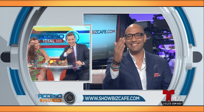 Two Acceso Total hosts interact with a smiling guest wearing glasses on screen