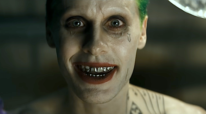 Jared Leto as Joker with green hair and metal teeth close-up