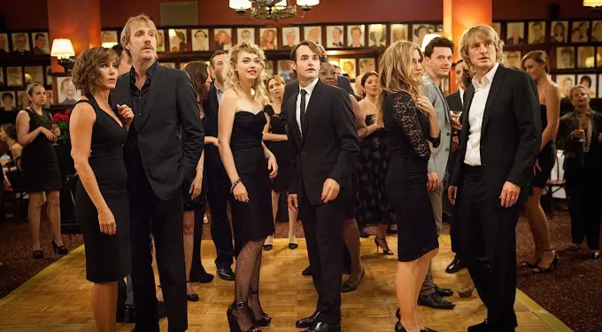 group of men and women dressed formally standing on a dance floor
