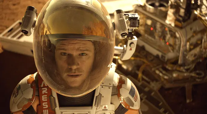 Matt Damon close-up in space suit and helmet on Mars