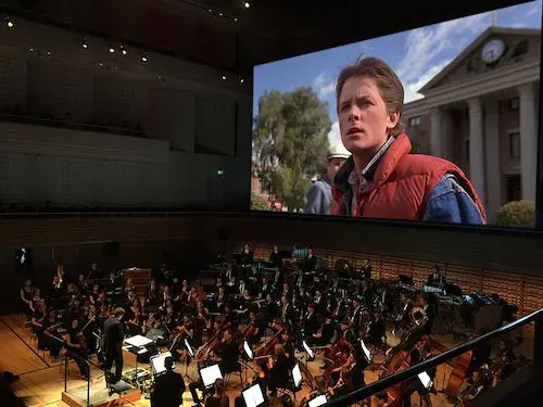 Orchestra performs as Back to the Future film plays on jumbo screen