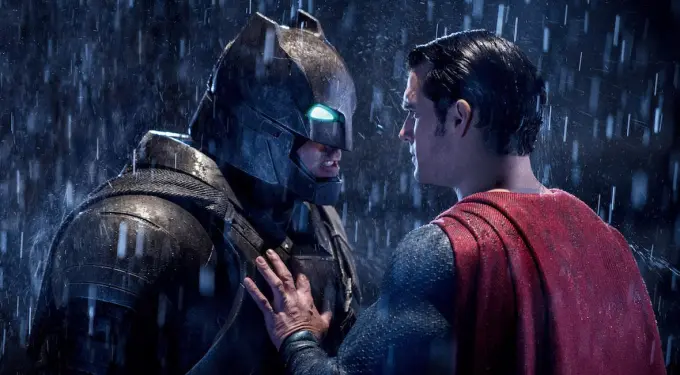 Batman and Superman confront each other in heavy rain