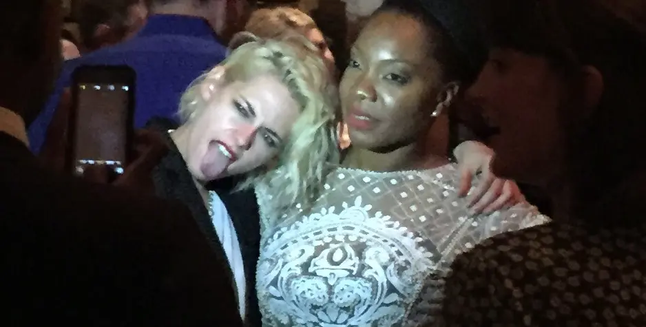 Kristen Stewart at the American Pastoral movie after-party at MOMA in 2016.
Kristen Stewart playfully sticks out tongue next to woman in white lace dress