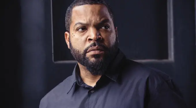 Ice Cube in a close-up headshot wearing black shirt looking to the side