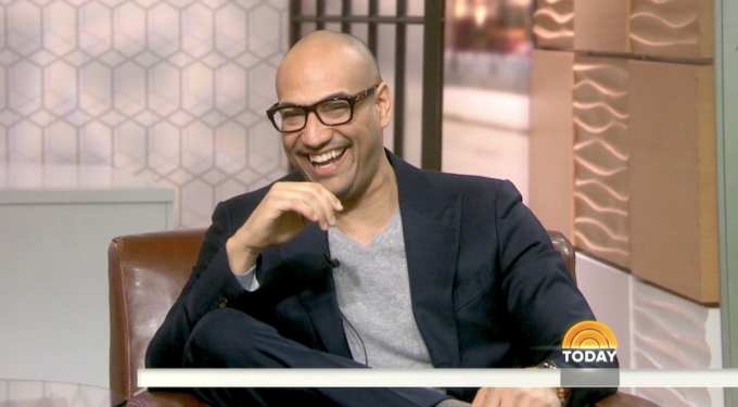 Man with glasses laughing while sitting in chair on Today show