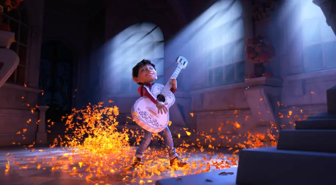 Miguel from Coco plays guitar with orange petals and light rays
