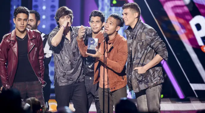 CNCO members accept award on stage at Premios Juventud