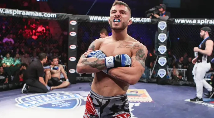 Marcelo Pitbull Rojo celebrating inside Combate Americas MMA cage