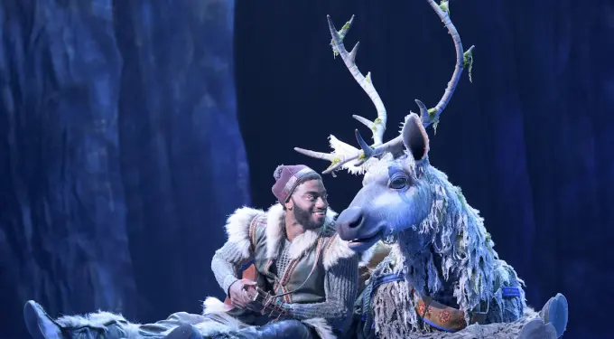 Jelani Alladin as Kristoff sitting next to Sven puppet by Andrew Pirozzi