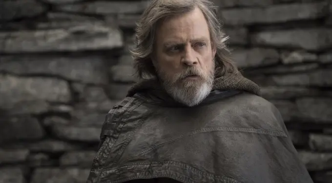 Mark Hamill as Luke Skywalker looks sideways in cloak