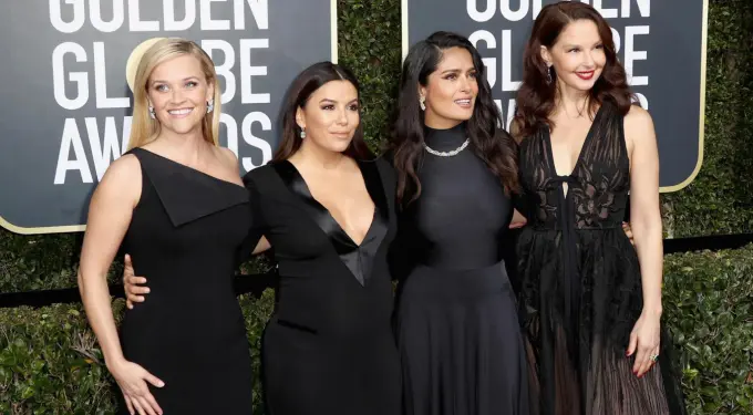 Four women dressed in black pose at 2018 Golden Globes red carpet