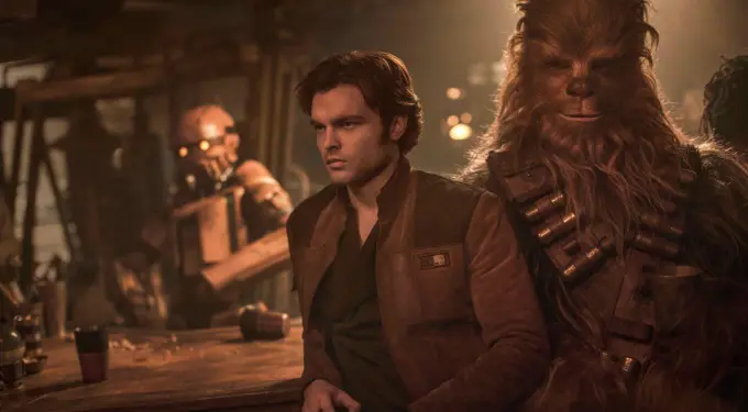 Han Solo and Chewbacca sit at bar with droid behind them