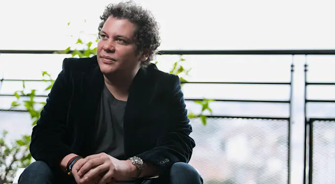 Colombian musician Chabuco seated outdoors looking to side