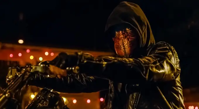‘El Chicano’ masked character rides motorcycle in nighttime scene
Masked figure in leather jacket on motorcycle at night