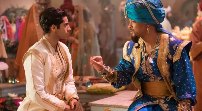 Scene from Aladdin showing characters in detailed traditional costumes having a conversation
Two men in Aladdin costumes talk in richly decorated room