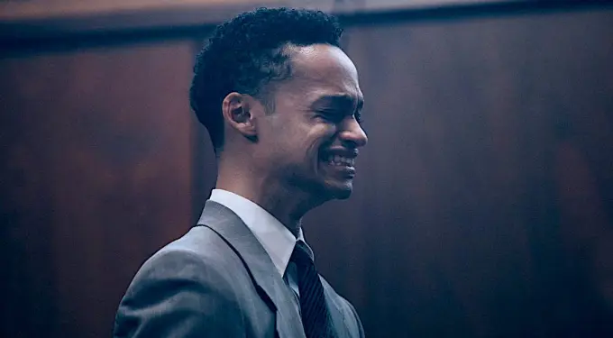 Marquis Rodriguez in an emotional moment from When They See Us
Marquis Rodriguez grimaces emotionally in a suit during dramatic scene