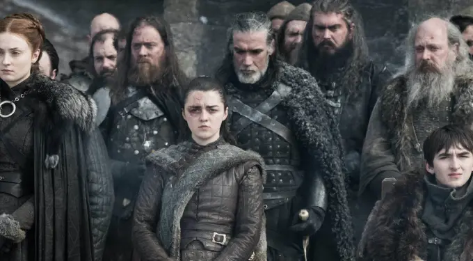 Scene from Game of Thrones season 8 episode with key characters gathered.
Game of Thrones characters stand in medieval costumes in serious scene