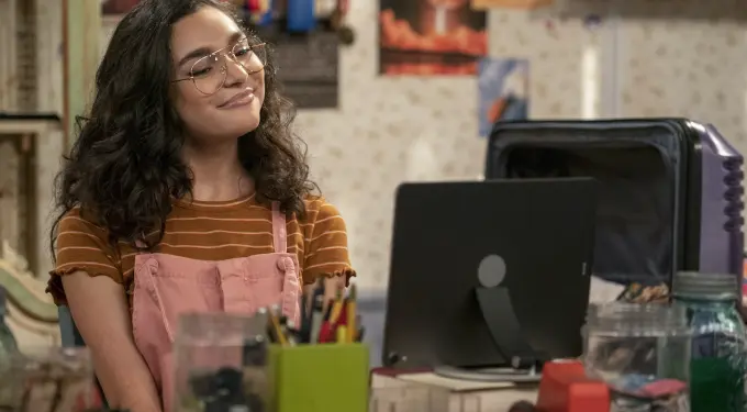 Paulina Chavez smiling, sitting at desk with computer in a scene