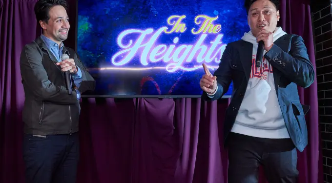 Lin-Manuel Miranda and Jon Chu speaking during an In The Heights event
Lin-Manuel Miranda and Jon Chu talk in front of In The Heights logo