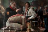 Guillermo del Toro directing Oscar Isaac on Frankenstein set with bound figure prop